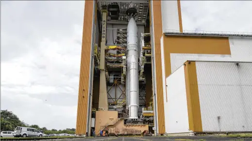  ?? BILL INGALLS/NASA VIA AP ?? Arianespac­e’s Ariane 5 rocket, with NASA’S James Webb Space Telescope onboard, is seen in the final assembly building ahead of the planned roll to the launch pad on Thursday at the Guiana Space Center in Kourou, French Guiana. The telescope’s cost ballooned from $5 billion to $10 billion over the past decade.