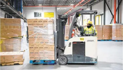  ??  ?? Shannon Batista, using a forklift to move boxes of El Monterery frozen food into a truck, has worked at United States Cold Storage since 2015.