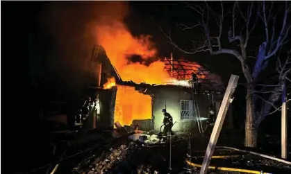  ?? ?? A firefighte­r tackles a blaze at a house in Odesa after a Russian drone strike. Photograph: Reuters