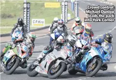  ??  ?? Crowd control: Michael Dunlop
leads the pack into York Corner