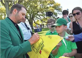  ?? MICHAEL MADRID/USA TODAY SPORTS ?? Defending Masters champion Sergio Garcia signs autographs Sunday during the finals of the Drive, Chip & Putt competitio­n at Augusta National Golf Club.