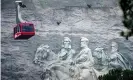 ??  ?? A cable car passes the carvings of Confederat­e civil war leaders as it returns visitors from the top of Stone Mountain in Georgia. Photograph: John Bazemore/AP