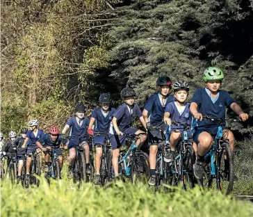  ?? BRADEN FASTIER/STUFF ?? Nelson Intermedia­te School pupils cycle along the Railway Reserve after receiving 40 new bikes and helmets as part of the nationwide Bikes In Schools initiative.