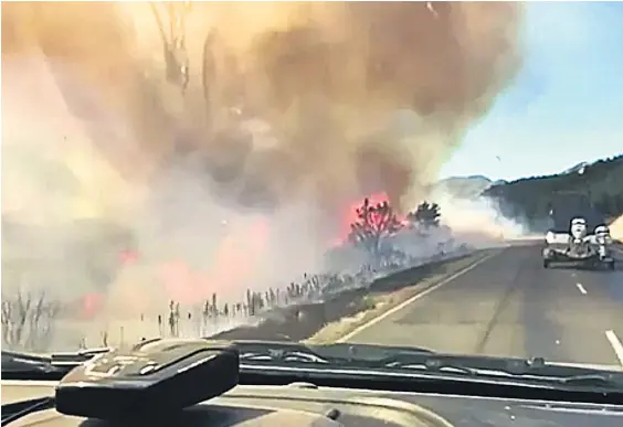  ??  ?? Dramatic dash cam footage shot before SH7 closed shows vehicles driving next to thick smoke and flames.
