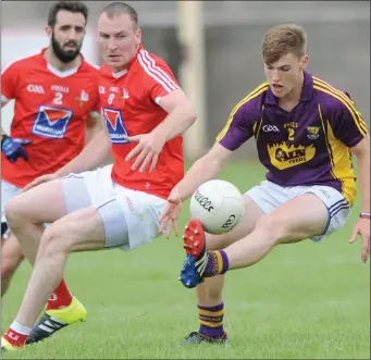  ??  ?? Wexford’s Jake Firman solos and turns as Tony McKenna closes in for Louth.