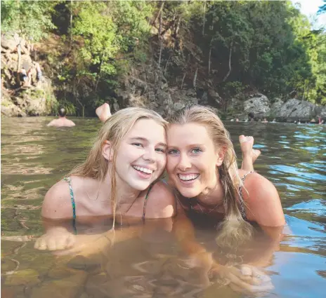  ?? Picture: MIKE BATTERHAM ?? Thousands of tourists such as Emerson Lees and Kate Harvey visit the Currumbin Rock Pools each year.