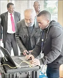  ?? ?? Chairman of the King’s Advisory Council (Liqoqo) Paul Dlamini having his fingerprin­ts taken during the registrati­on exercise at Lozitha Palace. (R) Liqoqo member and Former Prime Minister Prince Mabandla also registered.