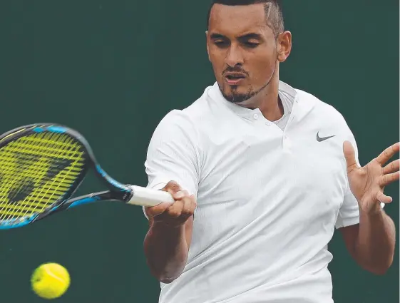  ?? Picture: AFP PHOTO ?? Australia's Nick Kyrgios returns against France's Pierre-Hughes Herbert, before retiring from their men's singles first round match at Wimbledon.