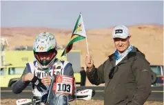  ?? ?? FATHERLY LOVE . . . Ashley Thixton (left) gets some tips from his father Trevor after the Zimbabwean biker managed to finish stage one of the Dakar Rally in Saudi Arabia on Saturday