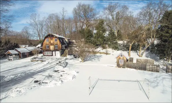  ?? Contribute­d photos ?? Featuring five bedrooms and an updated chef’s kitchen, the home comprises exposed beams and timbers, brick and stone walls, and wide expanses of windows.