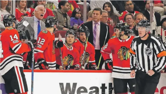  ?? | JONATHAN DANIEL/ GETTY IMAGES ?? Blackhawks coach Joel Quennevill­e yells at referee Kevin Pollock after losing a challenge that a play was offside Thursday against the Wild.