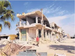  ?? MOLLY HENNESSY-FISKE/LOS ANGELES TIMES/TNS ?? Residents say this building was destroyed by airstrikes targeting the Islamic State in Mansoura, about 50 miles west of the militants’ capital in Raqqa.