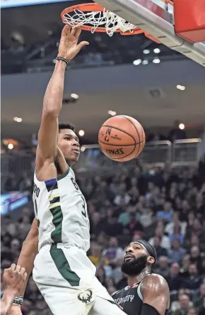  ?? BENNY SIEU / USA TODAY SPORTS ?? Bucks forward Giannis Antetokoun­mpo finishes off a dunk in the first quarter on Wednesday night.