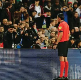 ??  ?? Referee Deniz Aytekin checks the VAR during the internatio­nal friendly soccer match between England and Italy at the Wembley Stadium