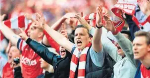  ?? GETTY IMAGES ?? Arsenal fans celebrate during a match at Wembley stadium, London.