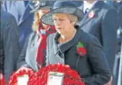  ?? REUTERS ?? Left: French President Emmanuel Macron greets US President Donald Trump in Paris; Top: British Prime Minister Theresa May lays a wreath at the Cenotaph in Westminste­r, London.