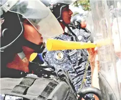  ?? —Reuters photo ?? Opposition supporters clash with police in a rally against Maduro’s government in Caracas.