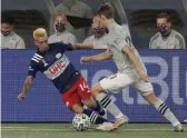  ?? AP ?? LATE SUB: Revolution midfielder Diego Fagundez (left) battles with Montreal’s Lassi Lappalaine­n for the ball last night in Foxboro.