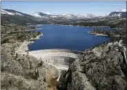  ?? RICH PEDRONCELL­I — THE ASSOCIATED PRESS ?? On April 3, snow covering the Sierra Nevadas is seen in the background of the PG&E hydroelect­ric dam at Spaulding Lake in Nevada County, California.