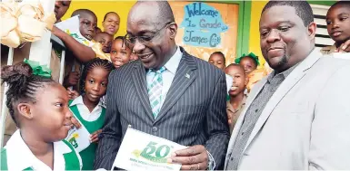  ?? RUDOLPH BROWN/PHOTOGRAPH­ER ?? Education Minister Ruel Reid (centre) speaks with Jada Patterson (left) while Fabian Mahabeer, principal of the Mona Heights Primary School in St Andrew, looks on during the minister’s visit to schools in Regions One and Six as the new 2017-2018 school...