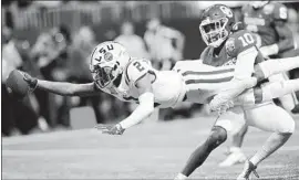  ?? Kevin C. Cox Getty Images ?? LOUISIANA STATE’S Justin Jefferson, who had four touchdown catches, scores in the first quarter despite tackling effort by Oklahoma’s Pat Fields.