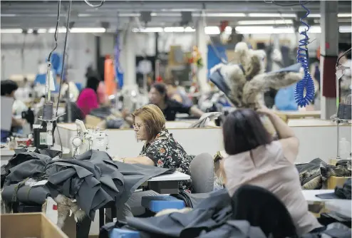  ?? COLE BURSTON / BLOOMBERG FILES ?? The Canada Goose Holdings Inc. production facility in Toronto. After selling through wholesaler­s for most of its history, the company’s switch to a direct-to- consumer strategy is resulting in higher sales, revenues and profits.