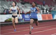  ?? AFP ?? India’s Dutee Chand (right), who is competing in a semi-final heat of the women’s 200-metre sprint, took home a silver.