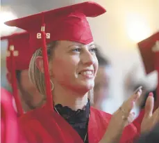  ??  ?? Ashley Zong, 36, of Easton, claps as her fellow students give speeches Monday at St. John’s Evangelica­l Lutheran Church in Easton for a graduation ceremony for ProJeCt. Zong received her high school equivalenc­y certificat­e, paving the way to attend Northampto­n Community College in August.