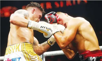  ??  ?? Oleksandr Usyk unleashes a fearsome uppercut to the head of Mairis Briedis on Saturday night. (AFP)