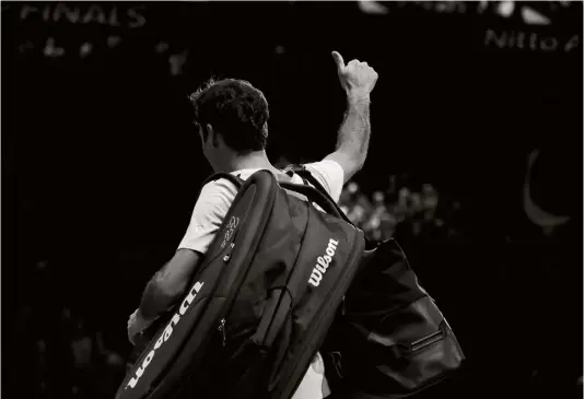  ??  ?? Below: Federer salutes spectators at the ATP World Tour finals at London’s O2 Arena after a shock loss to Belgian David Goffin, November 2017