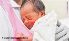  ??  ?? A newborn at a hospital in Tokyo.