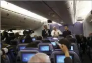  ?? THE ASSOCIATED PRESS ?? Pope Francis, flanked by father Mauricio Rueda, delegate for the organizati­on of the papal journeys, right, and Greg Burke, spokesman of the Vatican, talks with journalist­s Sunday during his flight from Lima, Peru, to Rome.