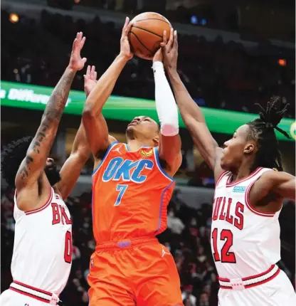  ?? AP ?? Thunder forward Darius Bazley takes the ball to the basket between Bulls guards Coby White (left) and Ayo Dosunmu on Saturday.