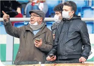  ??  ?? Roma fans wear protective face masks during their Serie A match against Lecce at the Stadio Olimpico last weekend