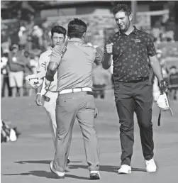  ?? JIM COWSERT/USA TODAY SPORTS ?? Jon Rahm, Sung King and Hideki Matsuyama congratula­te each other following play on the 18th green during the first round of the AT&T Byron Nelson golf tournament on Thursday.