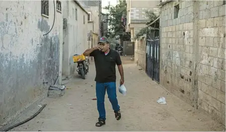  ?? FATIMA SHBAIR/AP ?? Ibrahim Slaieh, a Palestinia­n, drinks coffee on Aug. 21 in the Gaza Strip before crossing the border to work at a grocery store in southern Israel.