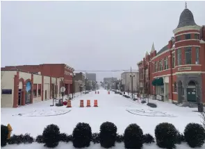  ?? (Pine Bluff Commercial/Byron Tate) ?? Main Street was mostly deserted on Monday after about 2 inches of snow and sleet fell Sunday night and Monday morning.