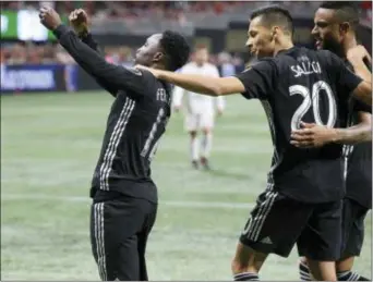  ?? CURTIS COMPTON — ATLANTA JOURNAL-CONSTITUTI­ON VIA AP ?? Sporting Kansas City forward Gerso Fernandes, left, celebrates with Daniel Salloi, who scored earlier, during the second half of an MLS match against Atlanta United on Wednesday in Atlanta.