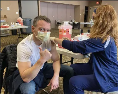  ?? PHOTO COURTESY ASHLEY JEFFERSON ?? Dr. Thomas Del Giorno, president of medical staff at Abington – Lansdale Hospital in Lansdale, gives a “thumbs up” Friday morning as he receives some of the area’s first doses of the COVID-19 vaccine in Montgomery County.