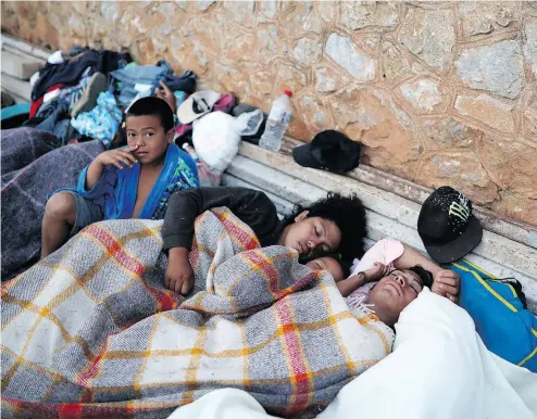  ?? FELIX MARQUEZ / THE ASSOCIATED PRESS ?? Migrants sleep in Matias Romero, Oaxaca State, Mexico on Tuesday. U. S. President Donald Trump referred to the caravan of Central Americans Tuesday, stating: “Republican­s must go to nuclear option to pass tough laws now.”