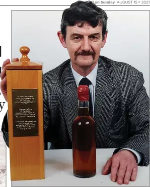  ??  ?? PRIZE POEM: Donald McLaren with his bottle of whisky, recovered from the wreck of the SS Politician in a 1987 dive sponsored by The Mail on Sunday, left