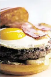  ?? James Nielsen / Houston Chronicle ?? Smoke burger (bacon, provolone, tomatoes, onions, fried egg, truffle bacon mustard, lettuce, milk bun)