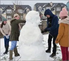  ?? Photo by Declan Malone ?? A day off school was no reason not to work and Samuel and Paige O’Malley, Shauna Cremin and Natalie Griffin got busy bringing a snowman to life in Dingle.
