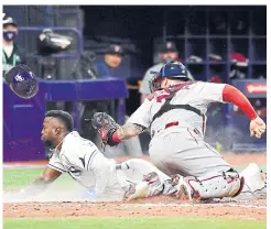  ?? AFP ?? The Rays’ Randy Arozarena, left, steals home against Boston.