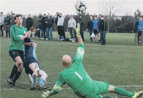  ?? Pictures by Brian Murfield ?? Jack Henshaw lifts over Paul Cull in Sleights’ derby win (above), and Jamie Wassall keeps out Karl Storr’s penalty (below)