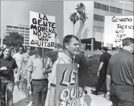  ?? Cal Montney Los Angeles Times ?? PROTESTERS march outside LAPD headquarte­rs after the June 1, 1968, indictment of 13 men connected to Chicano student walkouts in East L.A. that year.