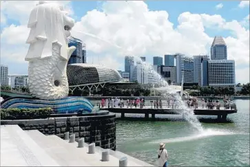  ?? Rosemary McClure ?? A MERLION — a mystical creature with a lion’s head and the body of a fish — keeps watch in Singapore.