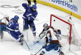  ?? CHRIS O’MEARA / ASSOCIATED PRESS ?? Lightning left wing Pat Maroon (top) scores past Avalanche goaltender Darcy Kuemper during the second period of Tampa Bay’s 6-2 win in Game 3 of the Stanley Cup Final on Monday in Tampa, Fla.