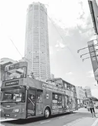  ??  ?? One of the 10 double-decker buses plying the streets of Penang soon after the launch Sunday.