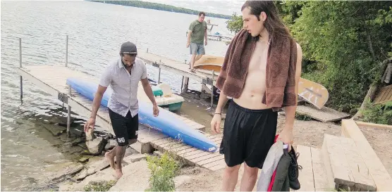  ?? PHOTOS: APRIL HICKOX ?? Above, Nicholas and Kolwyn — with Michael in the background — on the family’s dock at Woodhaven, their lakeside bed-and-breakfast north of Peterborou­gh, Ont. Top, from left: Michael hugs his son, Nicholas; Michael and David with young Nicholas and...